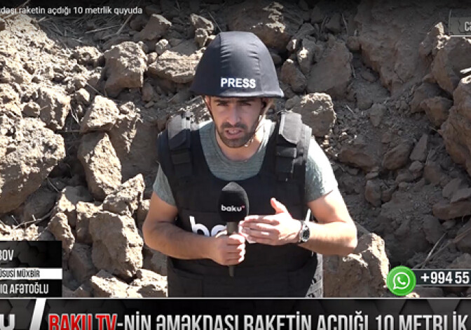 Сотрудник Baku TV в 10-метровой яме, образовавшейся в результате ракетного обстрела (Видео)